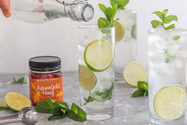 Pouring cold iced soda water into the glass