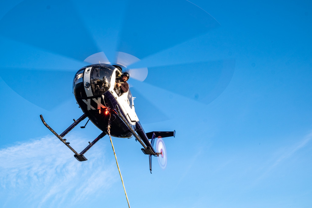 helecopter being used to collect bee hives full of manuka honey
